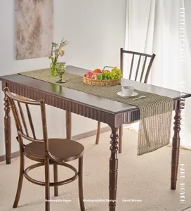 Detail of eco-friendly woven paper table runner showing natural texture on wood