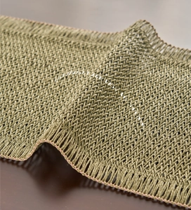 Detail of olive green woven table runner showing fine mesh texture and edge stitching