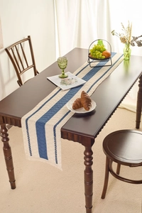 Close-up of blue and beige woven cotton linen table runner with tassel fringe