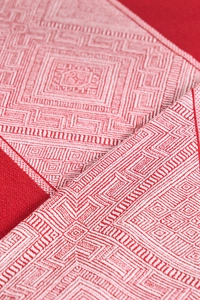 Close-up of red and white ethnic geometric pattern on thick cotton linen tablecloth