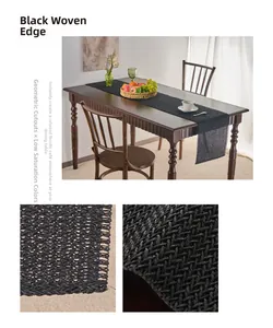 Detail of black woven table runner featuring geometric hollow design and rolled edges