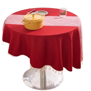 Red round linen cotton tablecloth with white pom pom fringe and geometric table runner