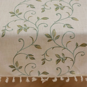Minimalist beige linen tablecloth with green leaf embroidery and delicate tassels