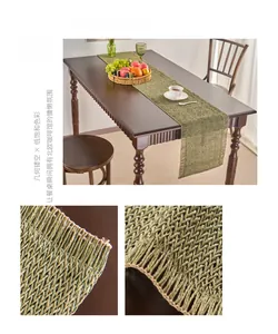 Detail of matcha green paper woven table runner with hollow geometric mesh and tassels