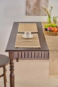 Macro shot of natural wood-colored woven table runner and placemat with fine tassels