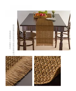 Macro shot of dark coffee paper woven table runner with geometric hollow patterns and tassels