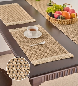 Macro detail of woven placemat texture with natural fringes on dark wood table