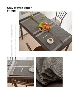 Detailed macro view of gray woven paper placemat texture and fringed edge craftsmanship