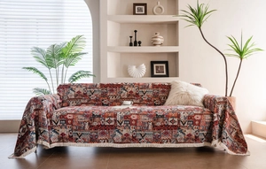 Detailed view of bohemian geometric sofa cover featuring ethnic patterns and fringe trim