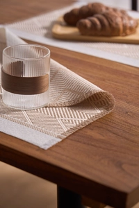 Macro detail of Nordic jacquard placemat with woven geometric patterns and frayed edges