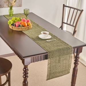 Green woven table runner in American pastoral style on a dark wood dining table