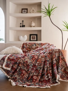 Detail of bohemian geometric jacquard sofa cover with fringe edges and thick texture