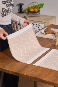Detail of bohemian geometric woven placemat with textured jacquard and long fringes