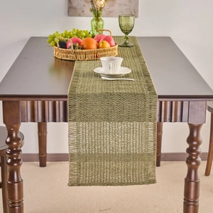 Green woven table runner with tassels on a dark wood table for rustic home decor