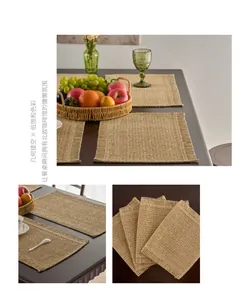 Close-up of khaki woven place mat featuring hollow geometric patterns and fringe edges