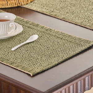 Green woven table runner in American rural style for coffee table on dark wood background