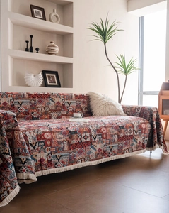 Close-up of thick bohemian jacquard sofa throw with retro geometric patterns and white tassels
