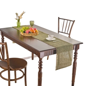 Green woven table runner in American pastoral style on a wooden dining table