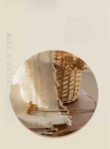 Detail von cremefarbenem Webstoff mit Quasten und geometrischen Lochmustern für Deko