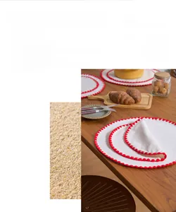 Detailed close-up of double-sided cotton linen placemat with red scalloped embroidery