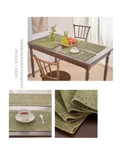 Detail of matcha green woven placemat with geometric hollow texture and tassels