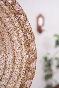 Macro shot of rustic jute woven placemat showing natural fibers and round hollow design