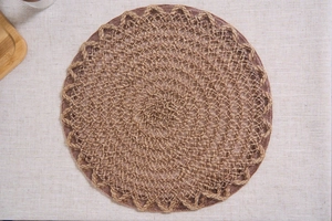 Macro detail of natural round woven placemat with elegant scalloped hollow edges