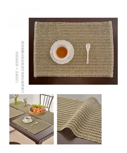 Close-up of matcha green woven placemat with geometric hollow texture and curled edges