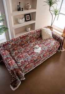 Detailed view of bohemian geometric jacquard weave with fringed edges on sofa cover