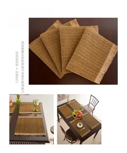 Macro detail of dark coffee woven paper placemat with dense fringe and geometric texture