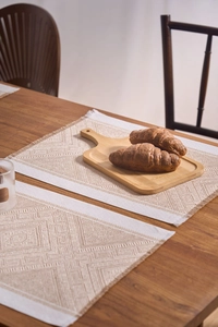 Detail of woven table mat with geometric diamond patterns and delicate fringe edges