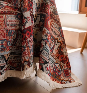 Macro shot of thick bohemian woven throw blanket with fringe edge and geometric texture