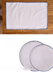 Detail of American rural style placemat with blue shell ripple embroidery and soft linen texture