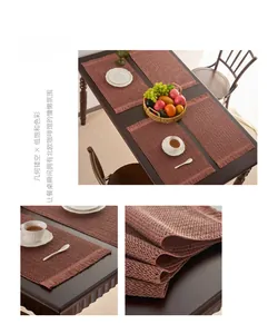 Detailed close-up of Raspberry Pink woven table mat with geometric cutouts and stylish tassels