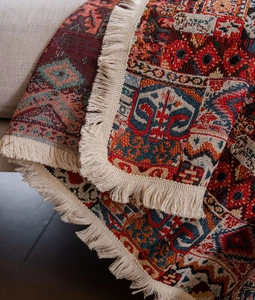Detailed close-up of Bohemian geometric jacquard sofa cover with fringe edges and thick fabric