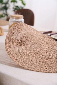 Detailed close-up of natural jute woven placemat showing intricate spiral texture