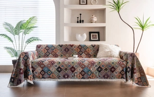 Macro view of bohemian geometric jacquard fabric featuring colorful diamond patterns and fringe