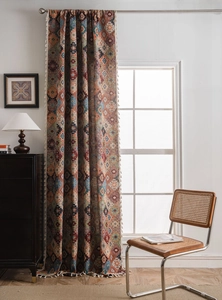 Detail of bohemian geometric jacquard curtain fabric with woven tassels and earthy tones