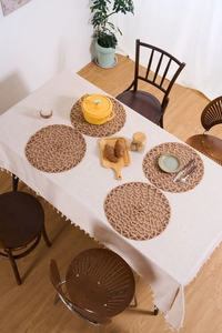 Top view of natural hemp rope placemats set with round hollow woven texture for table decor
