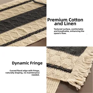 Detailed macro view of woven cotton linen table runner with wide black stripes and white tassels