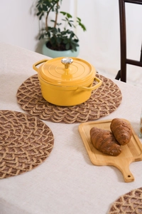 Round woven hemp rope placemat with hollow design in a kitchen lifestyle setting
