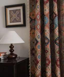 Detailed view of bohemian jacquard fabric with geometric patterns and fringe tassels