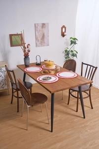 Close-up of modern dining chair with fan-shaped cutout backrest and metal legs