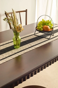 Detailed close-up of knitted table runner featuring black and white diamond weave texture