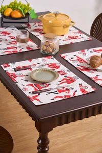 Detail of Christmas table mats with Santa Claus motifs on a rustic wooden table
