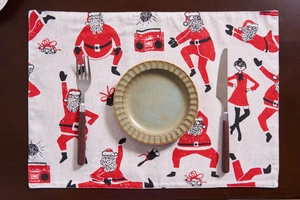 Detail of Christmas table mat with Santa Claus patterns on a rustic wooden background