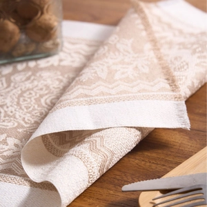 Nordic jacquard placemat with woven fringe edges on a wooden dining table background