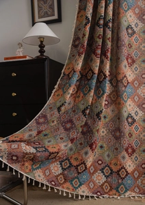 Detail of bohemian geometric jacquard fabric with tassels and textured diamond patterns