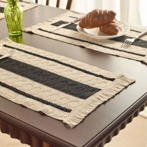 Modern black and white striped table runner with woven texture and tassels for home decor