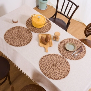 Set of 4 rustic round woven table mats made of natural jute for heat protection and decor
